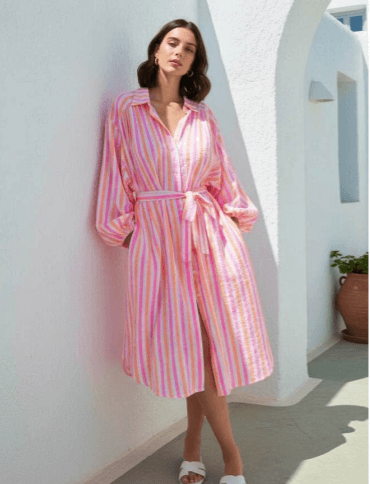 Model in vibrant striped Carlotta Shirt Dress with a classic collar and belt, perfect for warm days.
