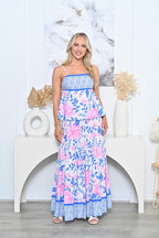 Model wearing Blushing Bouquet Top with floral print and adjustable straps, styled elegantly in a bright setting.