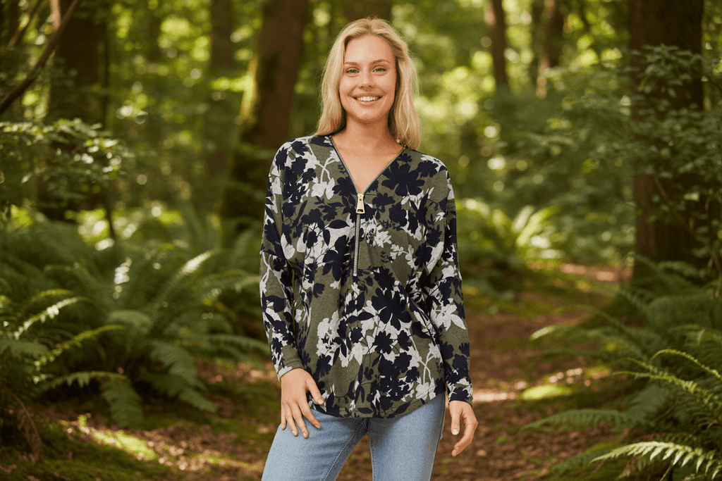 Model wearing the Valery Zip Top in a forest, showcasing casual elegance and comfort with a modern V-neckline.