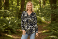 Model wearing the Valery Zip Top in a forest, showcasing casual elegance and comfort with a modern V-neckline.