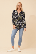 Model wearing a floral Valery Zip Top paired with jeans, showcasing relaxed elegance and style.