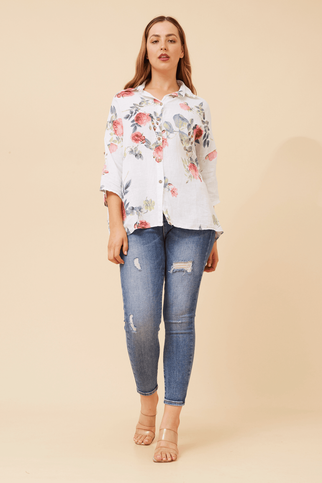 Eira Roll up sleeve shirt featuring floral design, relaxed fit, and paired with ripped jeans for a stylish look.