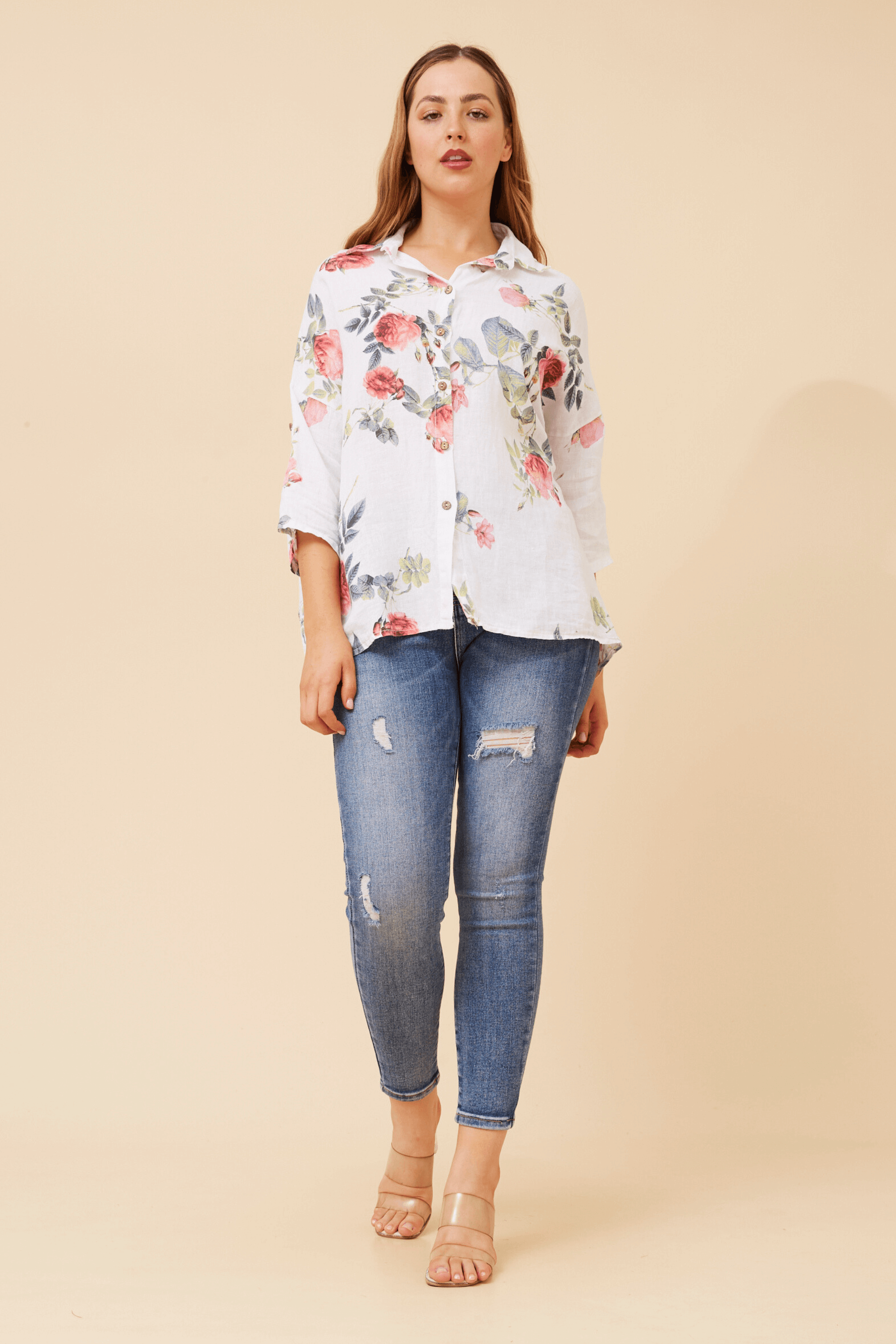 Eira Roll up sleeve shirt featuring floral design, relaxed fit, and paired with ripped jeans for a stylish look.