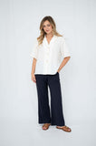 Model wearing a chic outfit featuring Straight Cut Trouser with side pockets and a relaxed button-up shirt.
