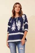 Model wearing Malta Top featuring 3/4 sleeves and border print on a light background.