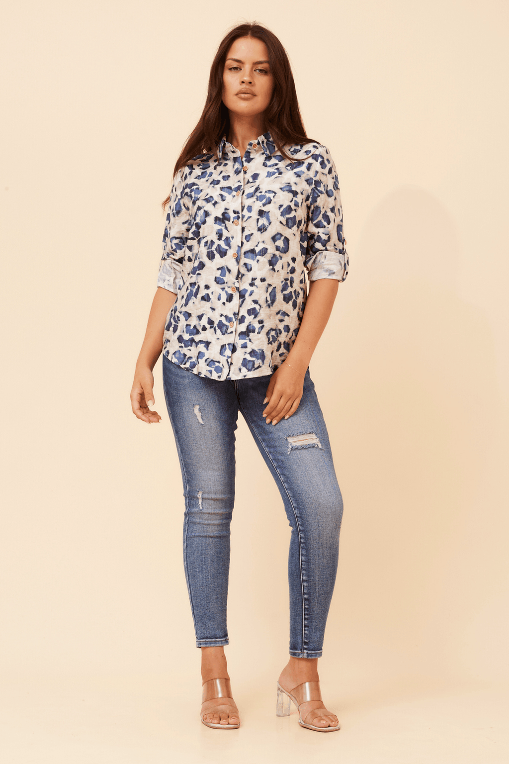 Zola Leopard Shirt styled with skinny jeans, showcasing its sophisticated long sleeve design and chic appearance.
