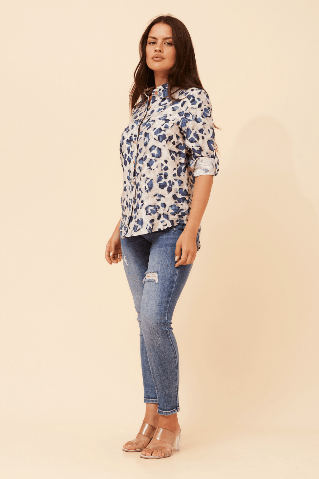 Model wearing the Zola Leopard Shirt with a stylish design and long sleeves, paired with fitted jeans and sandals.