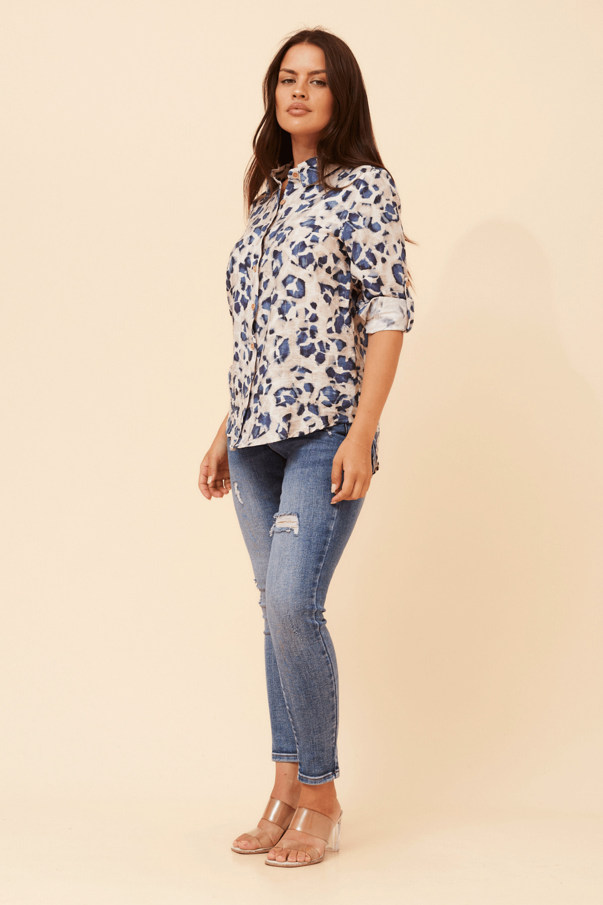 Model wearing the Zola Leopard Shirt with a stylish design and long sleeves, paired with fitted jeans and sandals.