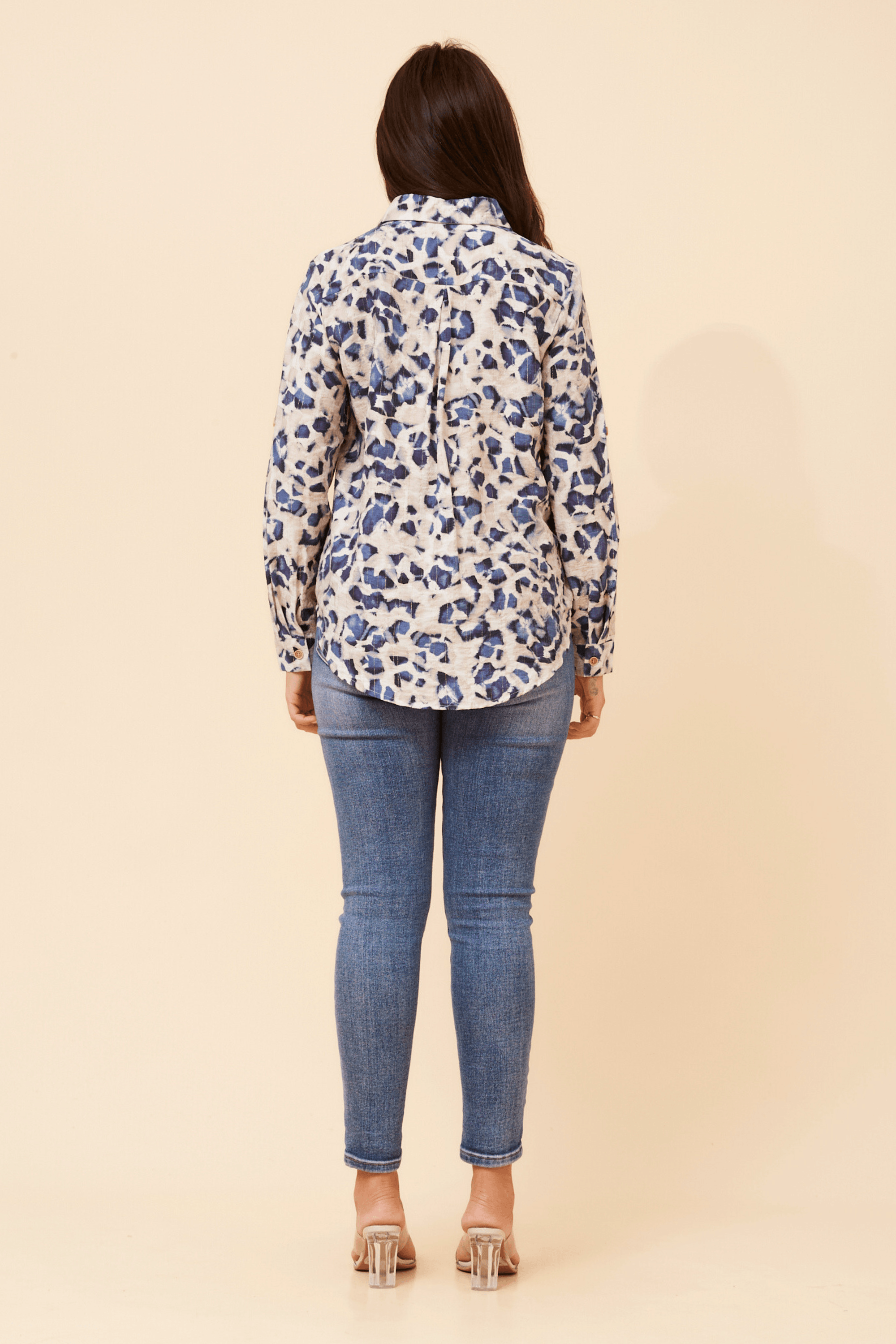 Back view of the stylish Zola Leopard Shirt paired with jeans, showcasing its sophisticated design and contemporary flair.