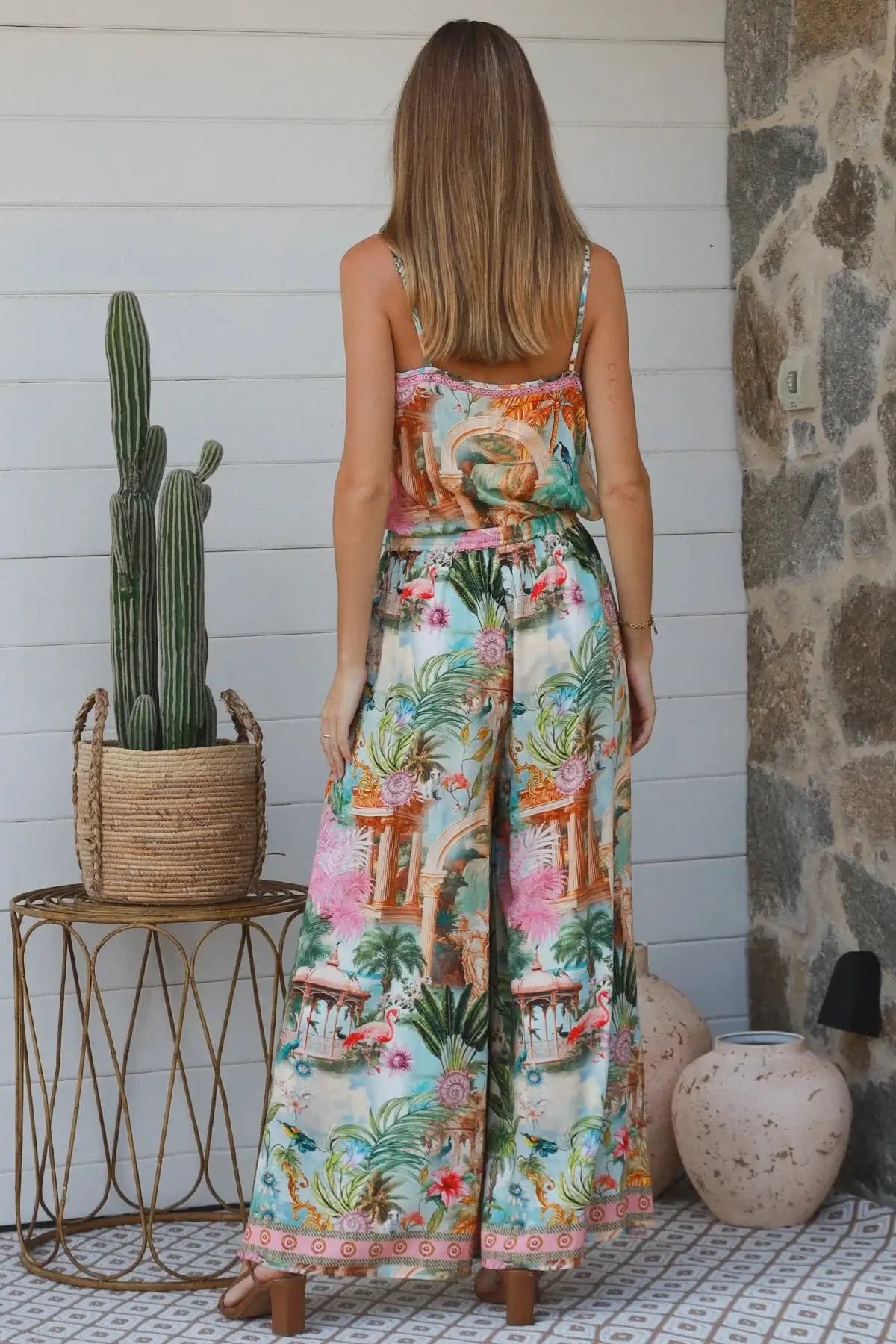Back view of a woman wearing Frances Pant with a vibrant Salty Palm print, featuring a tie and elastic waist.