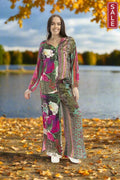 Woman wearing Digital Pants Flora by Orientique in colorful floral design by the lake during autumn.