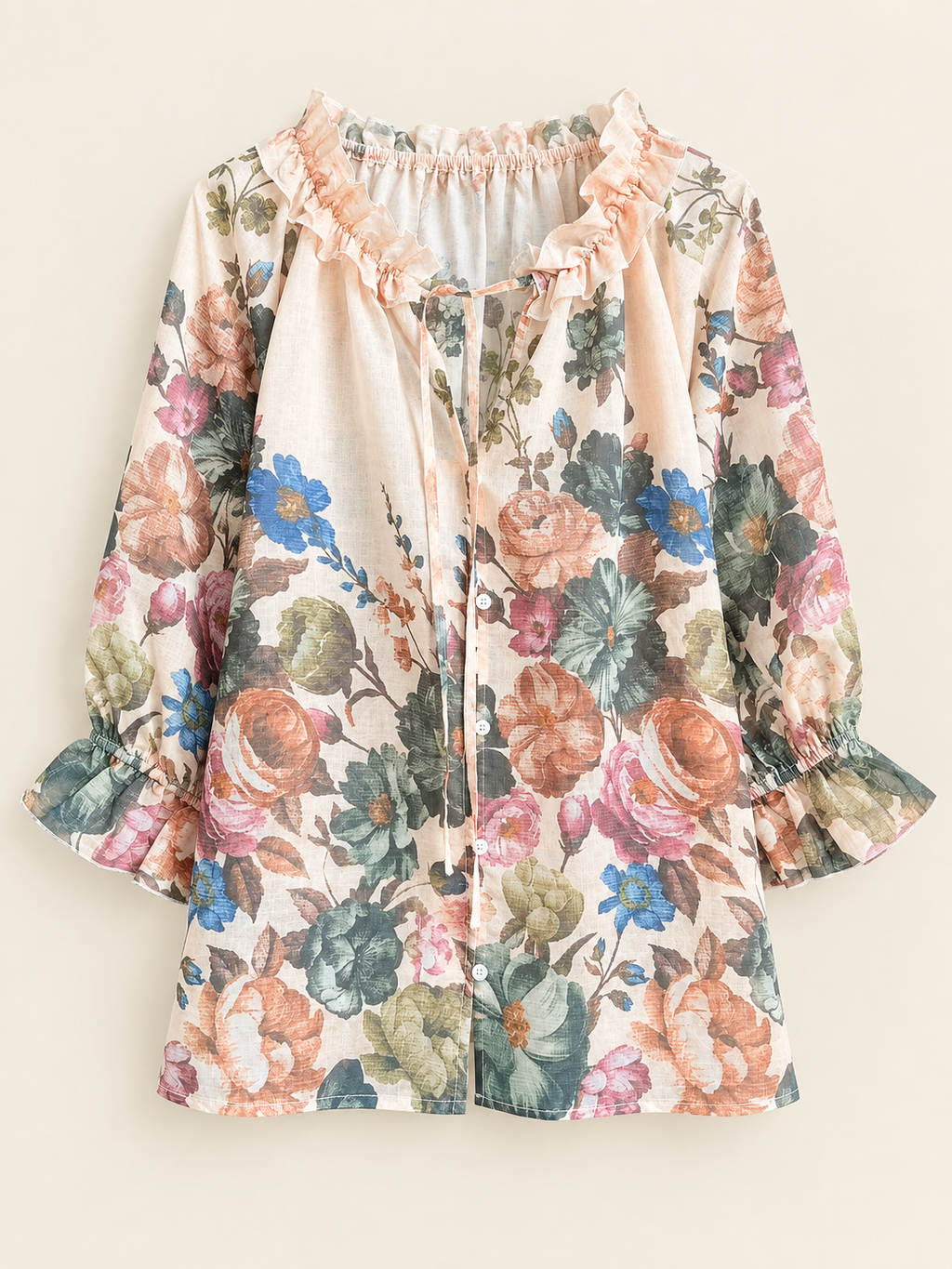 A long-sleeve blouse with a multicolor floral print on a cream background, featuring ruffled trim at the neckline and cuffs, displayed against a solid light beige background.