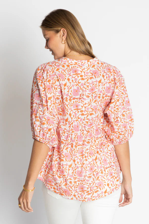 Back view of a woman wearing the Michigan Top, a floral cotton top with loose sleeves and elastic cuffs.