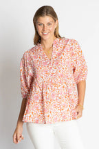 Michigan Top featuring a pink floral pattern, relaxed fit, and stylish V-neckline for laid-back days.