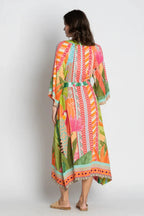 Back view of the colorful Los Carbos Midi dress featuring tropical print and wide sleeves.