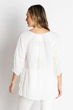 Back view of the Celeste Top featuring a relaxed fit, scooped neckline, and intricate ladder lace design.