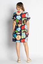 Back view of Melrose Dress Navy featuring vibrant prints and short cuffed sleeves.