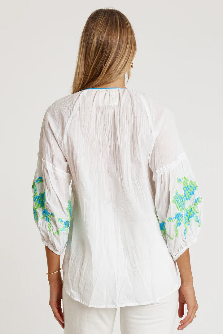 Model wearing the LulaLife Rosalind Top White, showcasing its embroidered sleeves and relaxed fit.