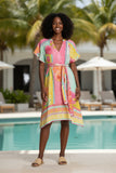 Caterina Dress Candy on a model by the pool, showcasing its vibrant colors and relaxed A-line style.
