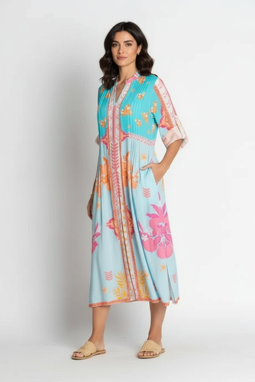 Espacio Midi Lagoon dress featuring vibrant floral print and relaxed silhouette perfect for summer outings.
