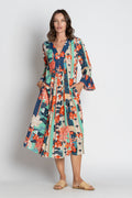 Model wearing the Wazuka Midi Navy dress featuring a V-neckline, floral print, and ¾ sleeves.