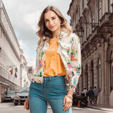Woman wearing the stylish Orientique Guatemala Jacket with vibrant patterns on a city street.