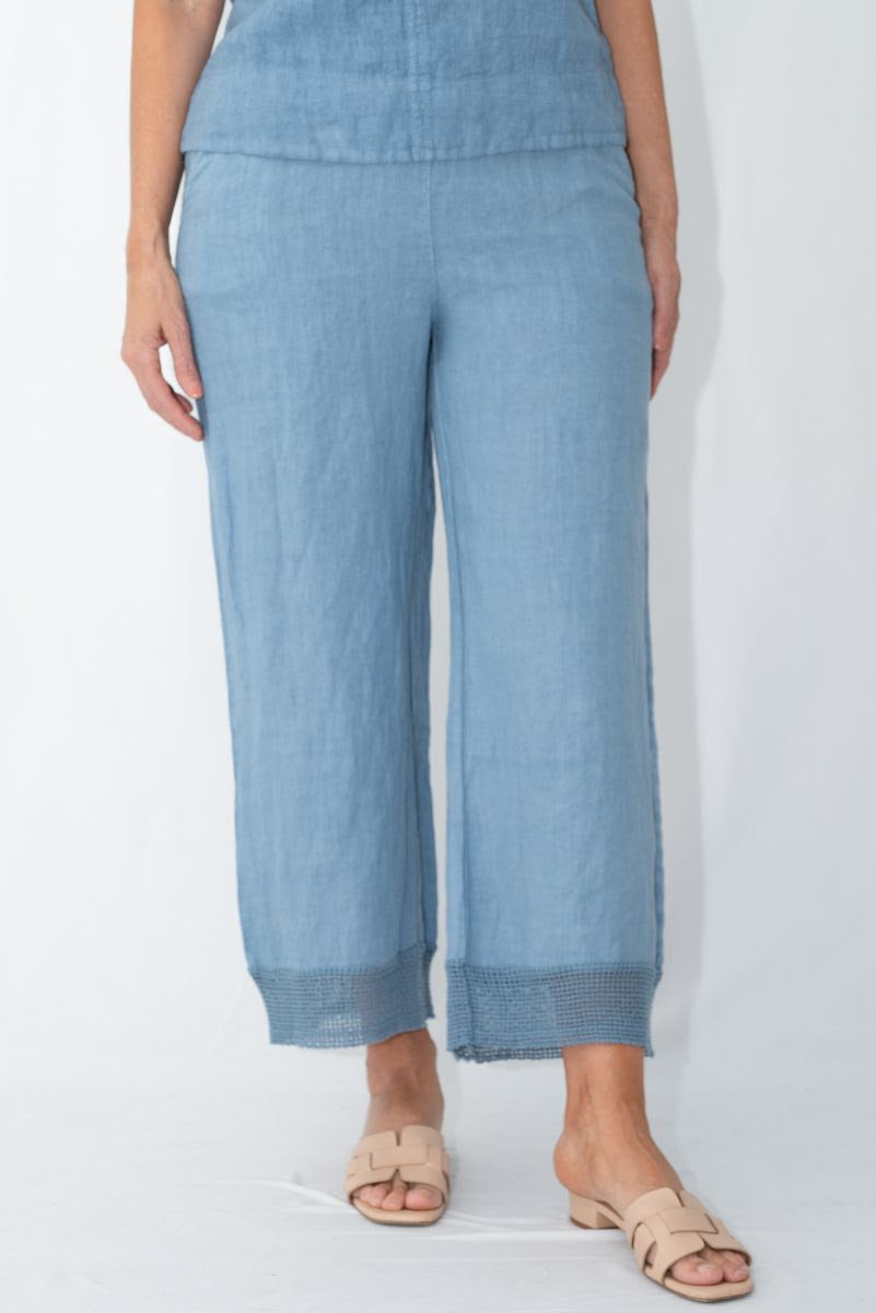 Model wearing Pari Linen Pants in light blue, showcasing relaxed fit and elegant design for casual and elevated occasions.