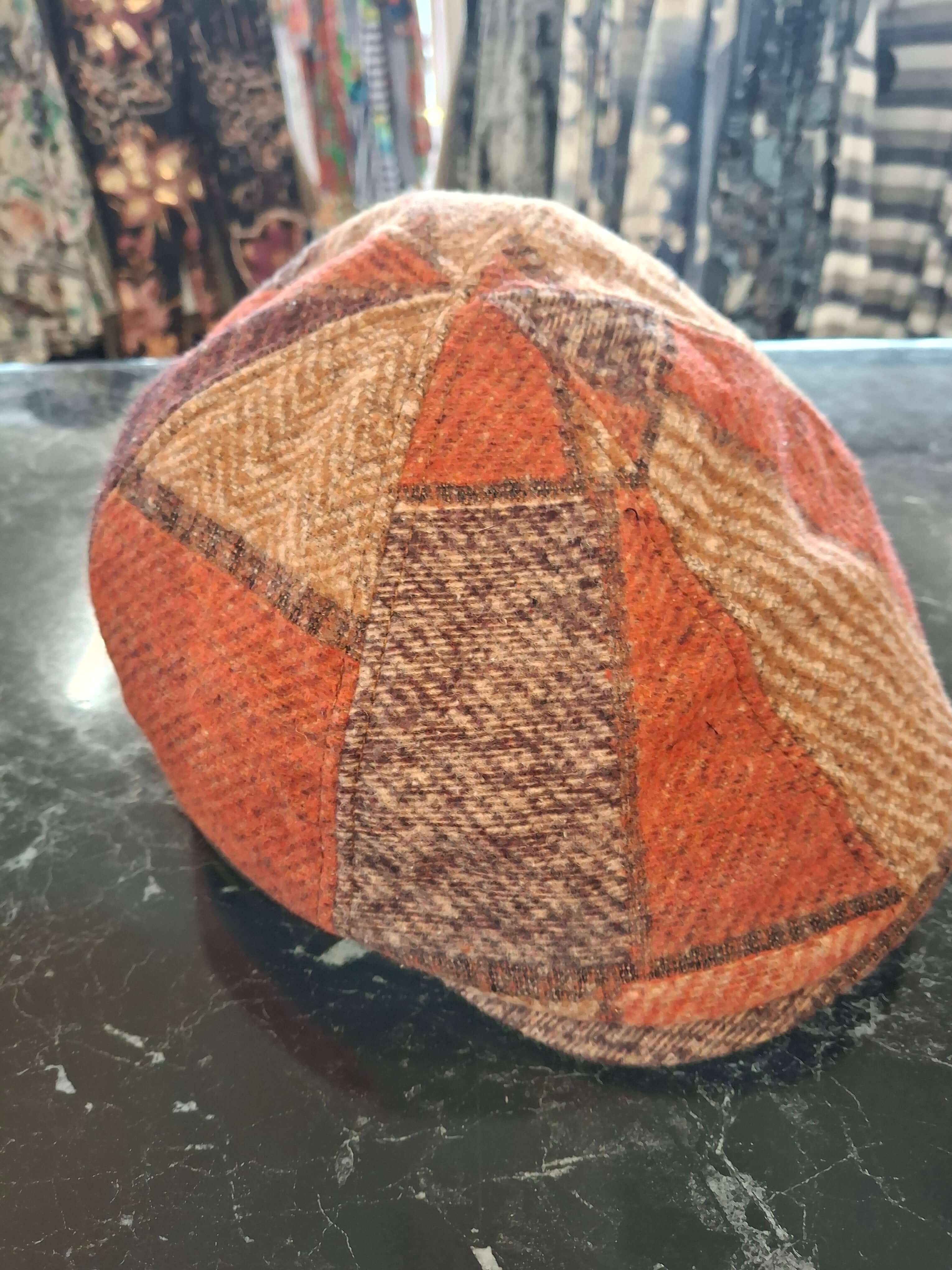 Charlie Check Cap in vibrant orange and brown patterns, showcasing classic flat cap style for modern comfort.