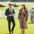 A couple enjoying a day out wearing the Charlie Check Cap at a horse racing event, showcasing timeless style.