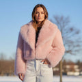 Chloe Faux Fur Jacket worn outdoors in winter, showcasing its luxurious pink faux fur and stylish cropped design.