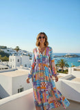 Model wearing Mallorca Maxi Dress with vibrant patterns in a scenic outdoor setting.