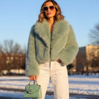 Chloe Faux Fur Jacket styled with sunglasses and green handbag in a snowy landscape.