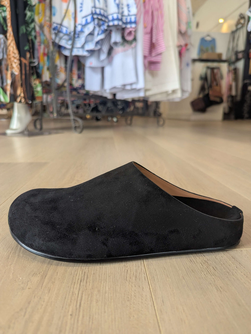 Los Cabos Lumi Slides featuring a black synthetic suede upper displayed in a retail setting.