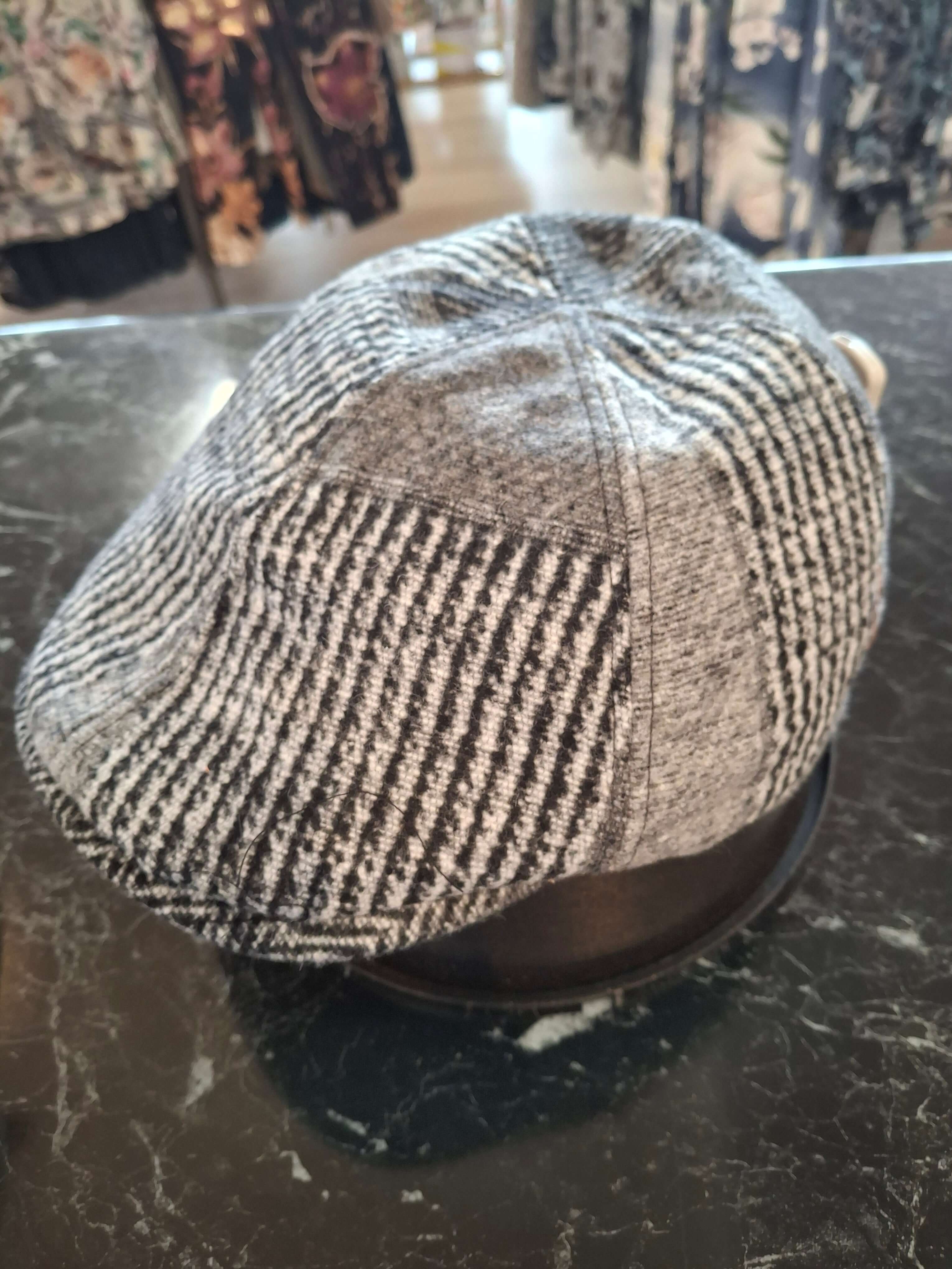 Charlie Check Cap shown in black and grey houndstooth design, perfect for elevating your casual style.