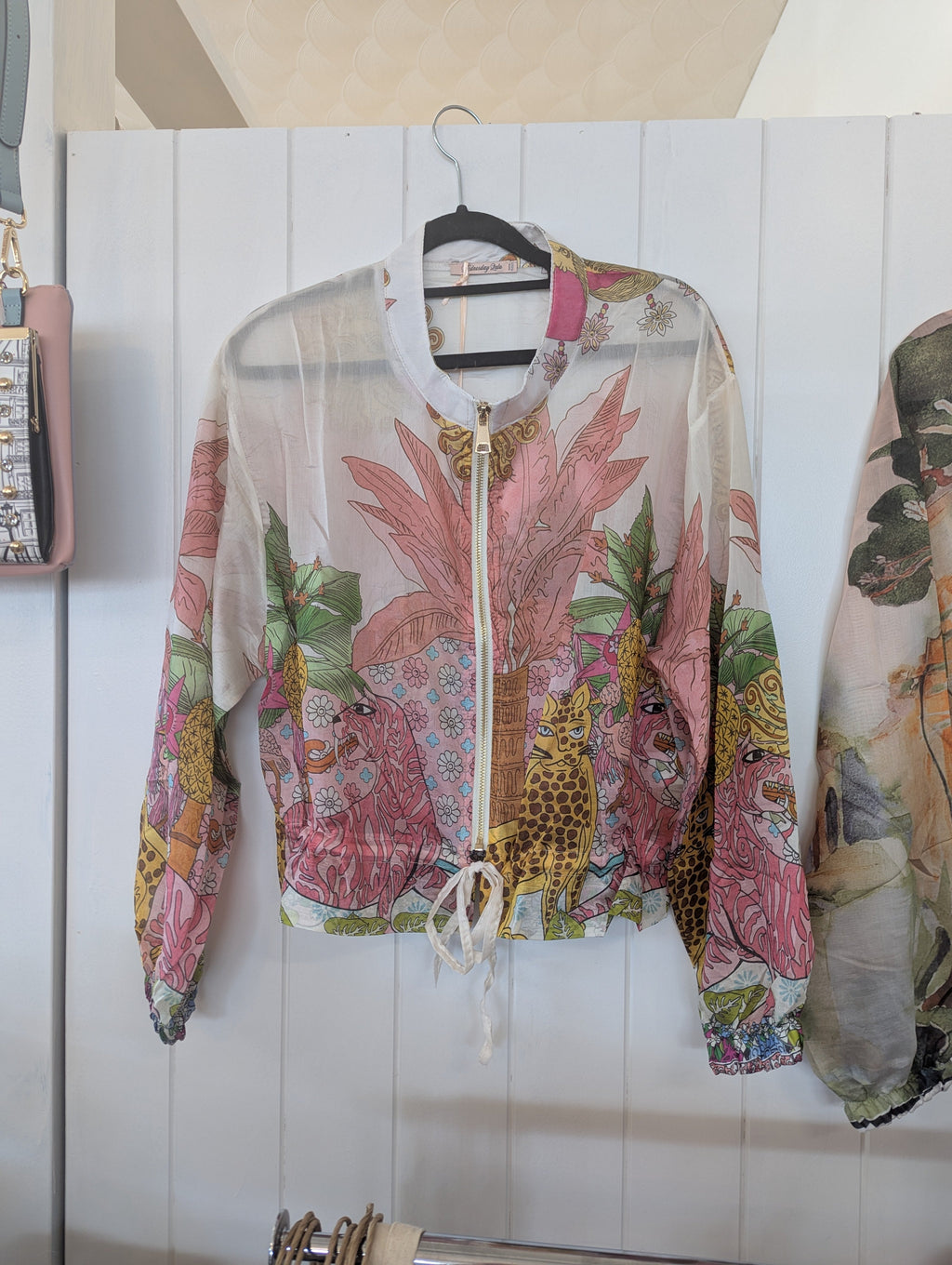 Gauri Zip Jacket featuring a vibrant, patterned design with lively colors and a stylish zip-front for layering.