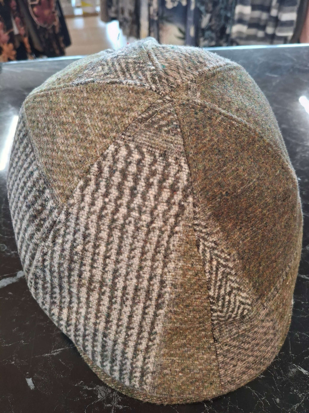 Charlie Check Cap showcasing a stylish patchwork design in earthy tones, perfect for elevating everyday outfits.