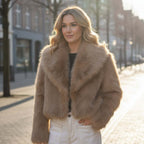 Chloe Faux Fur Jacket worn by a woman in a sunlit urban setting, showcasing its luxurious cropped design and big collar.