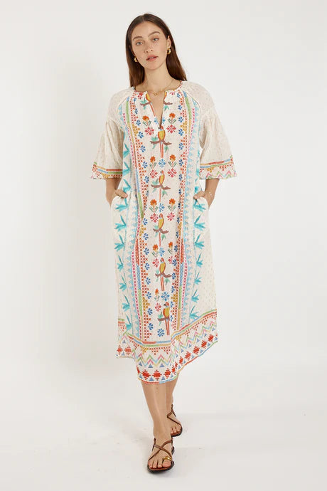 Biscay Maxi White dress by Rubyyaya featuring colorful embroidery and relaxed fit with side pockets.
