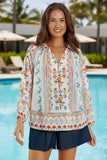 A woman in a colorful patterned shirt smiling by the pool, showcasing the Biscay Shirt White style.