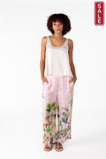 Model wearing Nouveau Pant Pink with a tank top, showcasing stylish summer fashion.