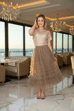 Model showcasing the SIS Mesh Skirt with a sparkling top in a luxurious restaurant setting.