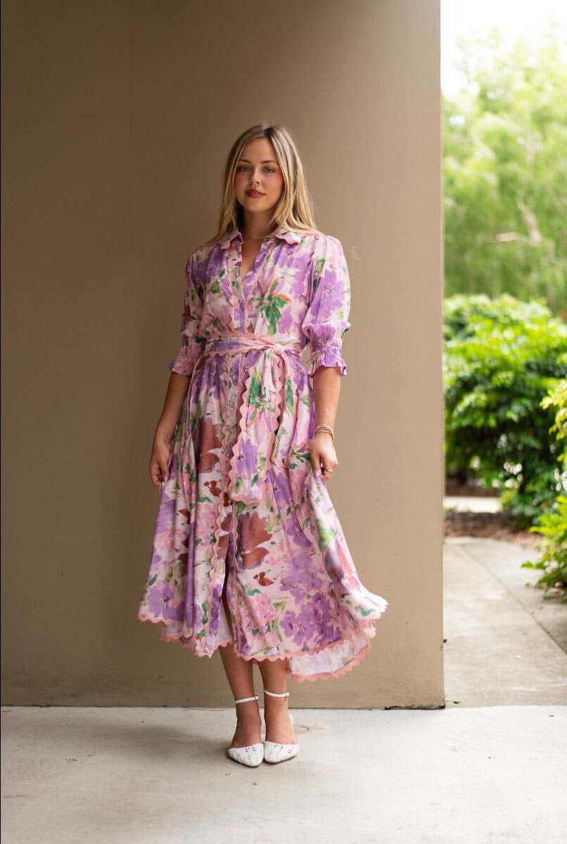 Model wearing the Mariana Floral Godet Dress featuring a floral pattern and elegant godet panels.