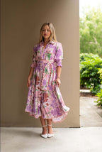 Model wearing the Mariana Floral Godet Dress featuring a floral pattern and elegant godet panels.