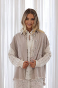 Freya Shacket displayed by a model, featuring cotton cable knit sleeves and brushed silver buttons.