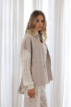 Freya Shacket featuring cotton cable knit sleeves and brushed silver buttons, stylishly posed against a backdrop.