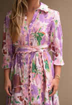 Model wearing the Mariana Floral Godet Dress, showcasing its vibrant floral patterns and elegant collar.