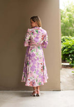 Back view of the Mariana Floral Godet Dress showcasing its floral design and elegant silhouette.
