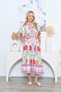 Waratah Shirt Dress featuring vibrant floral print, short sleeves, and cinched waist, styled for a chic look.
